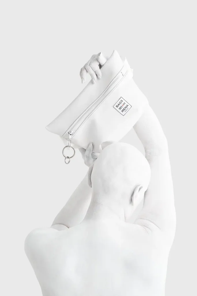 White bodypainted persons back, while holding back
