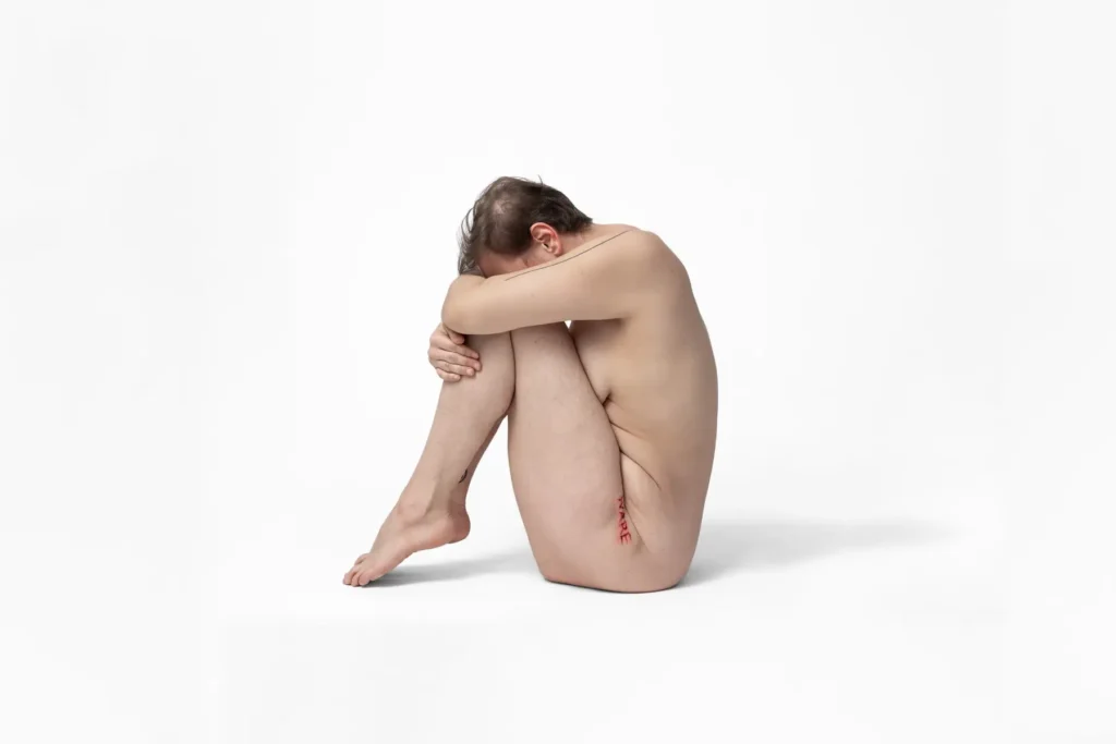 Whole body from the side, hiding face