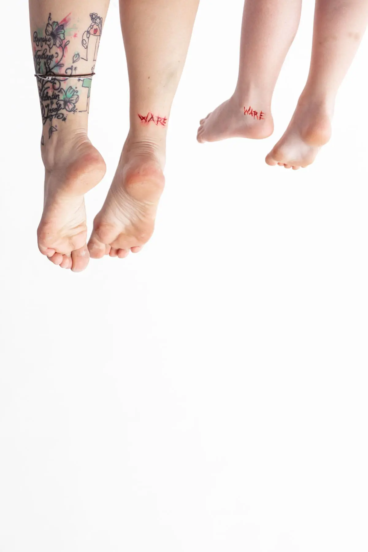 Feet of mother and child hanging