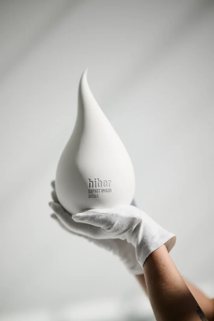 White sculptures shaped like a drop or flame