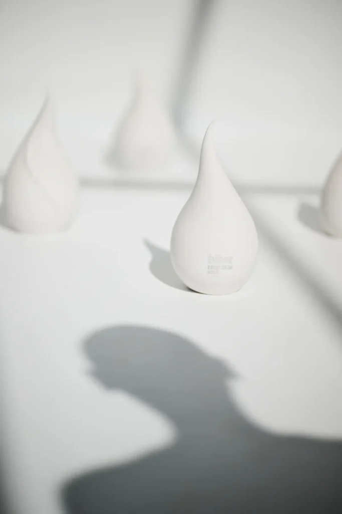 White sculptures shaped like drop or flame
