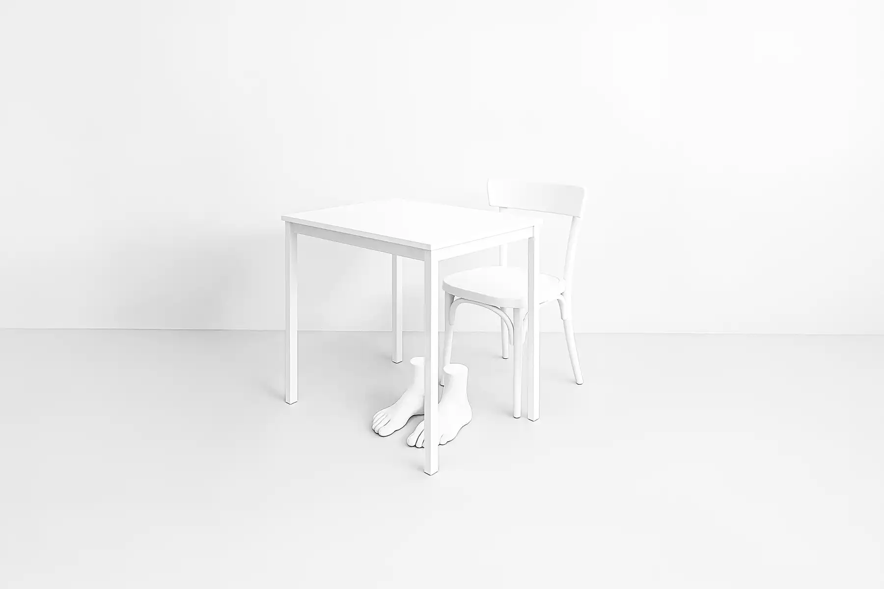 Table, a chair and a sculpture of feet.