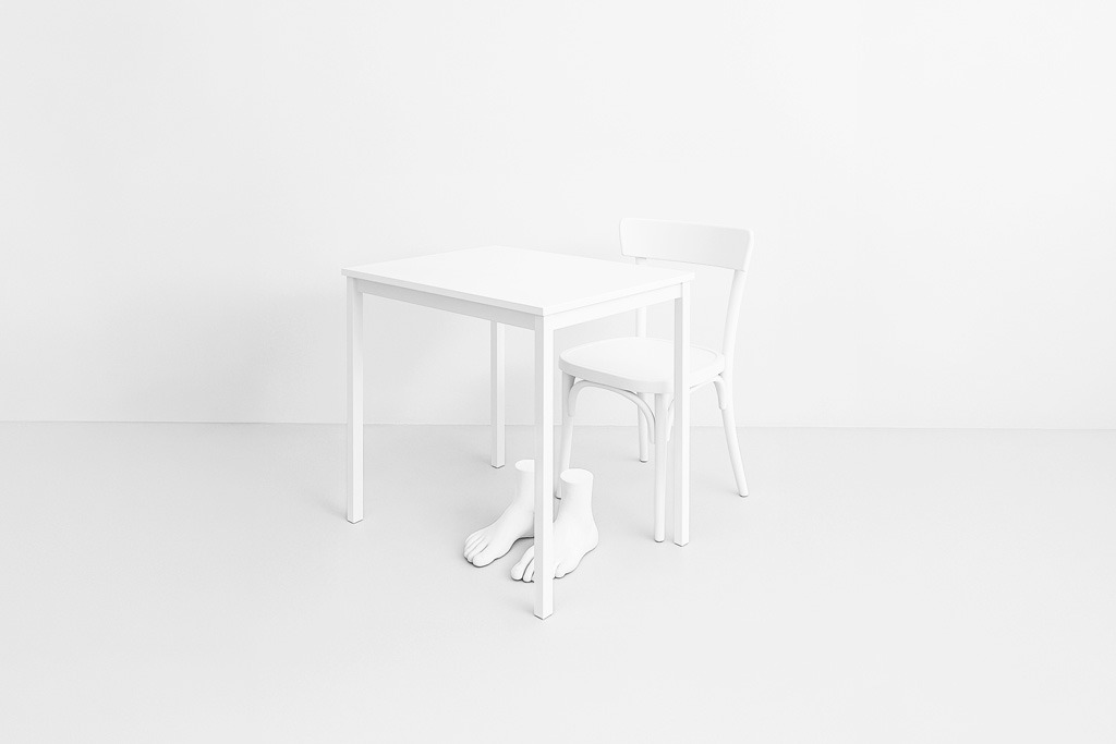 Table, a chair and a sculpture of feet
